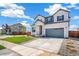 A beautiful two-story house with a big yard, a driveway, and a two-car garage at 2177 Garden Ave, Brighton, CO 80601