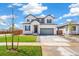 An attractive two-story home with a well maintained lawn and a two-car garage at 2177 Garden Ave, Brighton, CO 80601