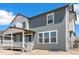 Side view of a two-story house with a covered porch and a spacious backyard at 2177 Garden Ave, Brighton, CO 80601