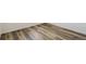 Close-up view of modern, wood-look flooring with a neutral, light color scheme at 2177 Garden Ave, Brighton, CO 80601