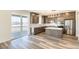 Modern kitchen featuring stainless steel appliances, center island, and stylish cabinetry at 2177 Garden Ave, Brighton, CO 80601