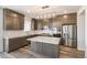 Bright kitchen boasts a center island, stainless steel appliances, and sleek modern finishes at 2177 Garden Ave, Brighton, CO 80601