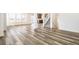 Spacious living area with wood flooring, natural light, and staircase view at 2177 Garden Ave, Brighton, CO 80601