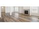 Inviting living room with a fireplace, light-filled windows, and wood flooring at 2177 Garden Ave, Brighton, CO 80601