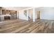 Bright open floorplan with kitchen, staircase and living space featuring light wood flooring at 2177 Garden Ave, Brighton, CO 80601