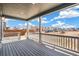 A covered porch provides an open view of the neighborhood on a sunny day at 2177 Garden Ave, Brighton, CO 80601
