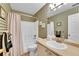 Charming bathroom featuring patterned wallpaper, shower-tub combo, and neutral vanity at 19447 E Bellisario Creek Dr, Parker, CO 80134