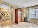 Open bedroom layout with wood flooring, a large wardrobe, and an ensuite bathroom at 19447 E Bellisario Creek Dr, Parker, CO 80134