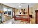 Spacious bedroom with a four-poster bed, wood floors, and bright natural light at 19447 E Bellisario Creek Dr, Parker, CO 80134