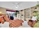 Bright bedroom featuring built-in shelving, plush bedding, and a view of the neighborhood at 19447 E Bellisario Creek Dr, Parker, CO 80134
