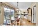 Bright dining area boasts wood floors, sliding glass doors to the patio, and access to the living room at 19447 E Bellisario Creek Dr, Parker, CO 80134