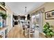 Bright dining area boasts wood floors, sliding glass doors to the patio, and access to the kitchen at 19447 E Bellisario Creek Dr, Parker, CO 80134
