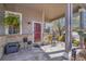 Charming front porch with seating area, potted plants, and a welcoming red door at 19447 E Bellisario Creek Dr, Parker, CO 80134