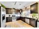 Well-equipped kitchen with stainless steel appliances, granite countertops, and dark wood cabinets at 19447 E Bellisario Creek Dr, Parker, CO 80134