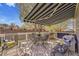 Inviting patio with awning, perfect for outdoor dining and relaxation at 19447 E Bellisario Creek Dr, Parker, CO 80134