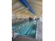 Indoor swimming pool with a blue lane divider, bright lighting and lots of natural light coming in at 19447 E Bellisario Creek Dr, Parker, CO 80134