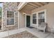 Inviting condo entrance with stone accents, covered entry and a cozy seating area at 3995 S Dillon Way # 102, Aurora, CO 80014