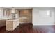 Open kitchen with light wood cabinets, stainless steel appliances, and hardwood floors at 3619 Navajo St, Denver, CO 80211