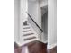 Staircase with dark wood steps and a metal railing at 3619 Navajo St, Denver, CO 80211