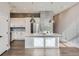 Modern kitchen boasts white cabinets, quartz counters, and stylish lighting at 2951 E Evans Ave, Denver, CO 80210