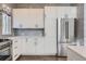 Modern kitchen with white cabinets and stainless steel appliances at 2951 E Evans Ave, Denver, CO 80210