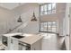 Open kitchen with island and stainless steel appliances at 2951 E Evans Ave, Denver, CO 80210