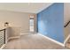 Bright loft area with window, carpet, and blue accent wall at 2951 E Evans Ave, Denver, CO 80210