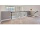 Spacious loft area with modern metal railing overlooking main living area at 2951 E Evans Ave, Denver, CO 80210