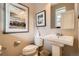 Well-lit half bathroom with modern fixtures and artwork at 8157 E 53Rd Dr, Denver, CO 80238