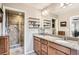 Bathroom featuring granite countertops, double sinks, and tiled shower at 8157 E 53Rd Dr, Denver, CO 80238