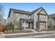 Charming gray two-story home with covered porch and manicured front yard at 8157 E 53Rd Dr, Denver, CO 80238