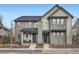 Attractive gray homes with inviting front porches and tasteful landscaping at 8157 E 53Rd Dr, Denver, CO 80238