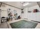 Spacious garage with ample storage, including cabinets and a pegboard wall for tools at 8157 E 53Rd Dr, Denver, CO 80238
