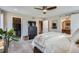 Spacious bedroom featuring a ceiling fan, a walk-in closet, and an ensuite bathroom at 8157 E 53Rd Dr, Denver, CO 80238