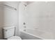 Clean bathroom with a white tiled bathtub and shower combination, alongside a modern toilet at 14147 Deertrack Ln, Parker, CO 80134
