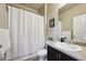 Bathroom featuring a sleek vanity, modern fixtures, and a shower with a clean white curtain at 443 Hermosa St, Brighton, CO 80603