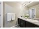 The well-lit bathroom features a double sink vanity at 443 Hermosa St, Brighton, CO 80603