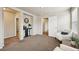 Large carpeted bedroom featuring stylish decor, neutral color palette, and bright natural light at 443 Hermosa St, Brighton, CO 80603