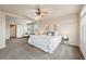 Large bright and airy bedroom with a ceiling fan, neutral walls, and many windows at 443 Hermosa St, Brighton, CO 80603