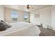 Light and airy main bedroom with large windows, ceiling fan, and a cozy seating area at 443 Hermosa St, Brighton, CO 80603