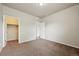 A spacious bedroom with an open closet and adjoining bathroom provides ample room and storage at 443 Hermosa St, Brighton, CO 80603