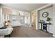 Large main bedroom with a sitting area, a fan, neutral decor and lots of natural light at 443 Hermosa St, Brighton, CO 80603