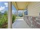 A covered front porch with brick at 443 Hermosa St, Brighton, CO 80603