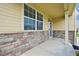 Charming front porch showcases brick accents, a covered entrance, and a cozy welcome at 443 Hermosa St, Brighton, CO 80603
