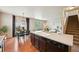 Open kitchen with a center island, dining area, and view of the living room at 443 Hermosa St, Brighton, CO 80603