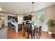 Stylish kitchen with dark cabinetry, stainless steel appliances, and an adjacent dining area at 443 Hermosa St, Brighton, CO 80603