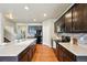Bright kitchen with wooden floors, a center island, and modern appliances at 443 Hermosa St, Brighton, CO 80603