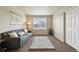 A living room with neutral walls, a plush rug, and a comfortable sofa at 443 Hermosa St, Brighton, CO 80603