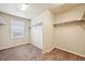 A well-organized walk-in closet provides generous storage, enhanced by natural light from a window at 443 Hermosa St, Brighton, CO 80603