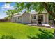 Backyard with a well-maintained lawn, patio, and grill at 3563 Watada Dr, Brighton, CO 80601